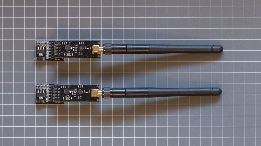 Two black RF PCBs with antennas